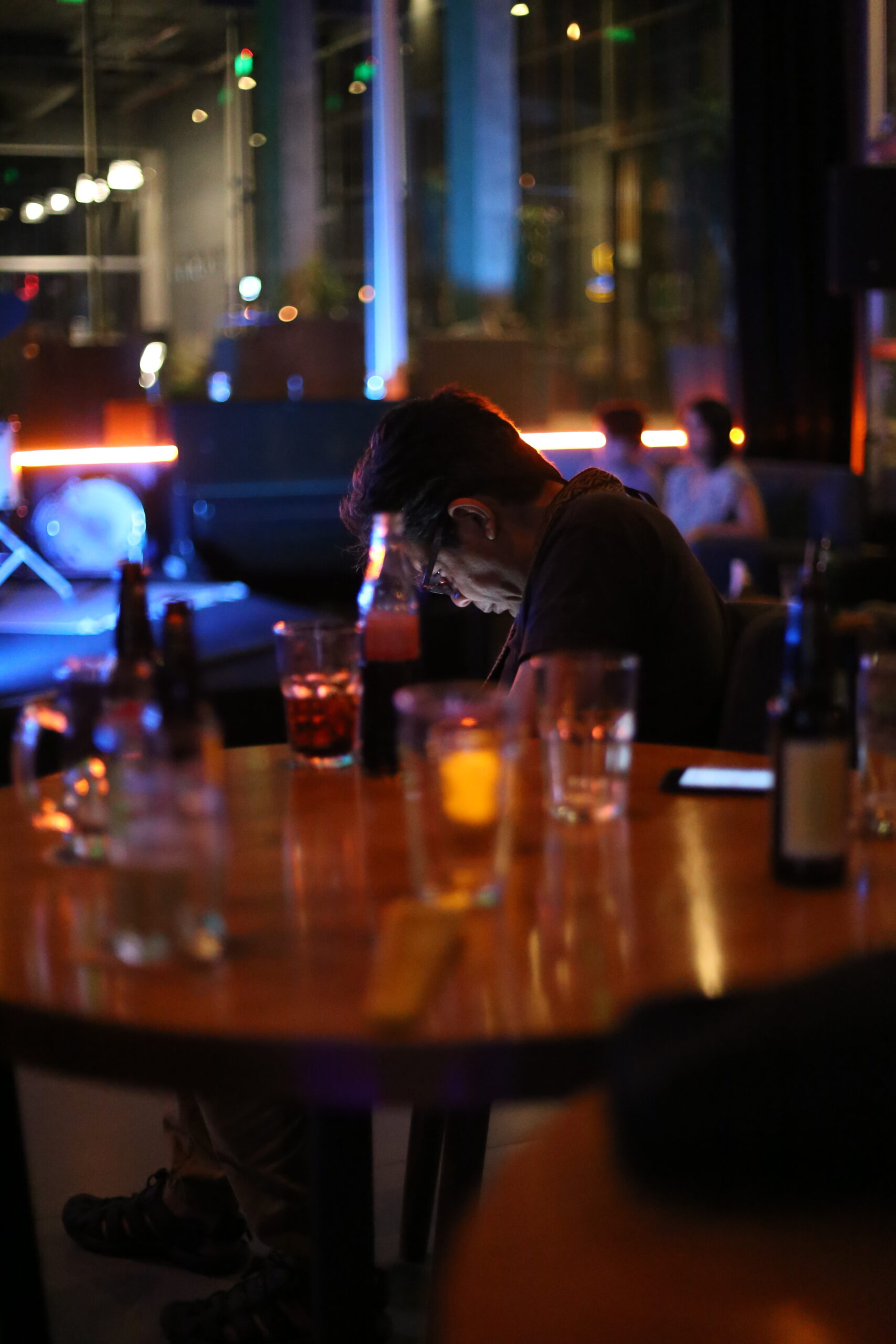 hombre revisando su celular en un bar